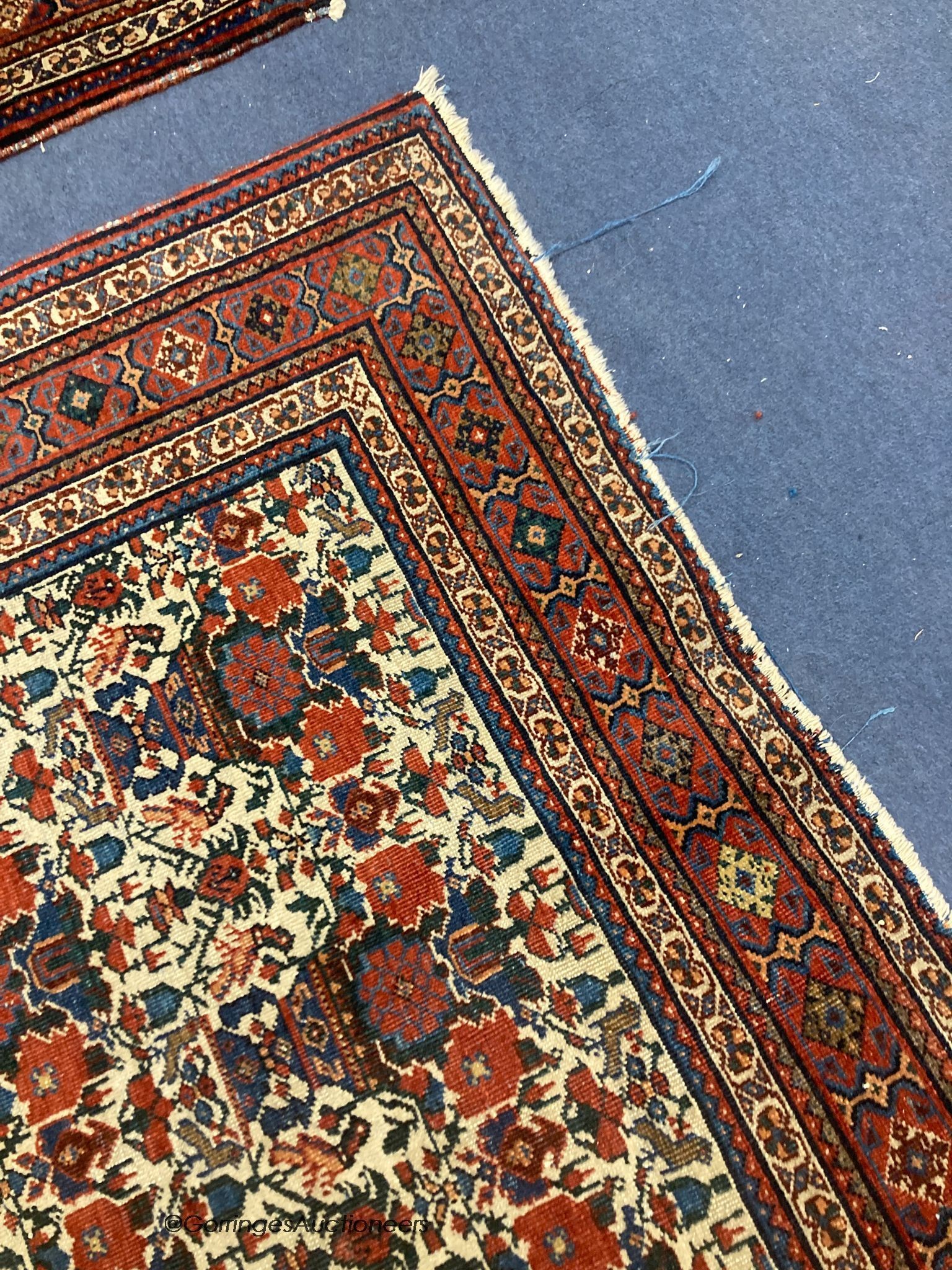 A pair of early 20th century North West Persian ivory ground rugs, woven with birds and vases of flowers, 150 x 110cm